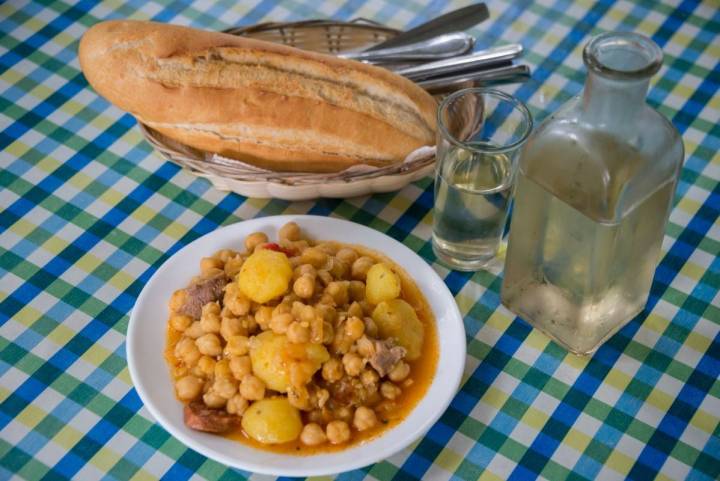 Plato de garbanzas junto al vino en una mesa del guachinche Las Galanas, en Tenerife.